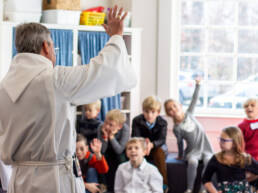 Children and rector in Sunday School