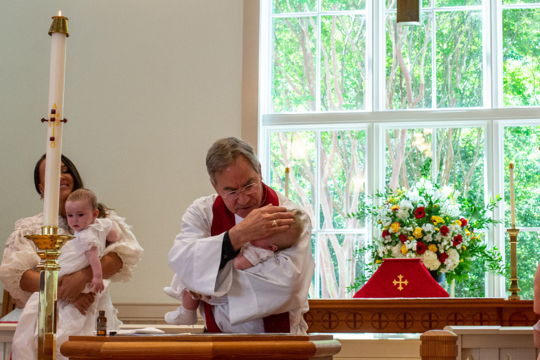 Rector baptizing a baby