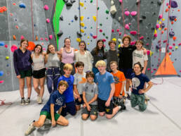 Youth at rock climbing gym smiling